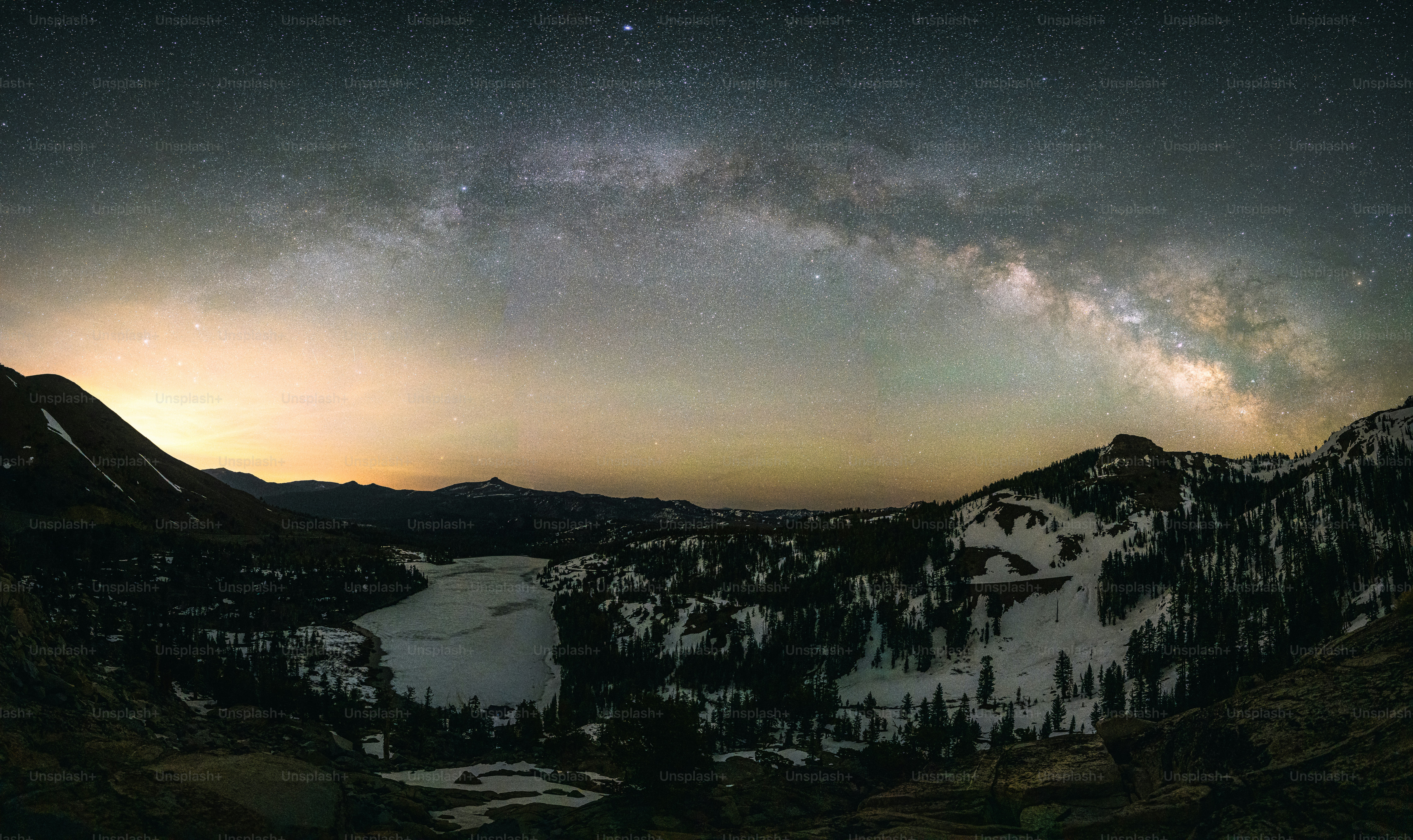 the night sky is filled with stars above a mountain range
