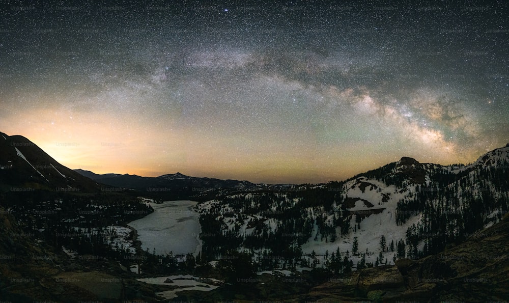 the night sky is filled with stars above a mountain range