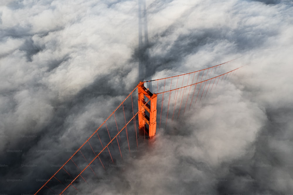 an aerial view of the golden gate bridge in the clouds