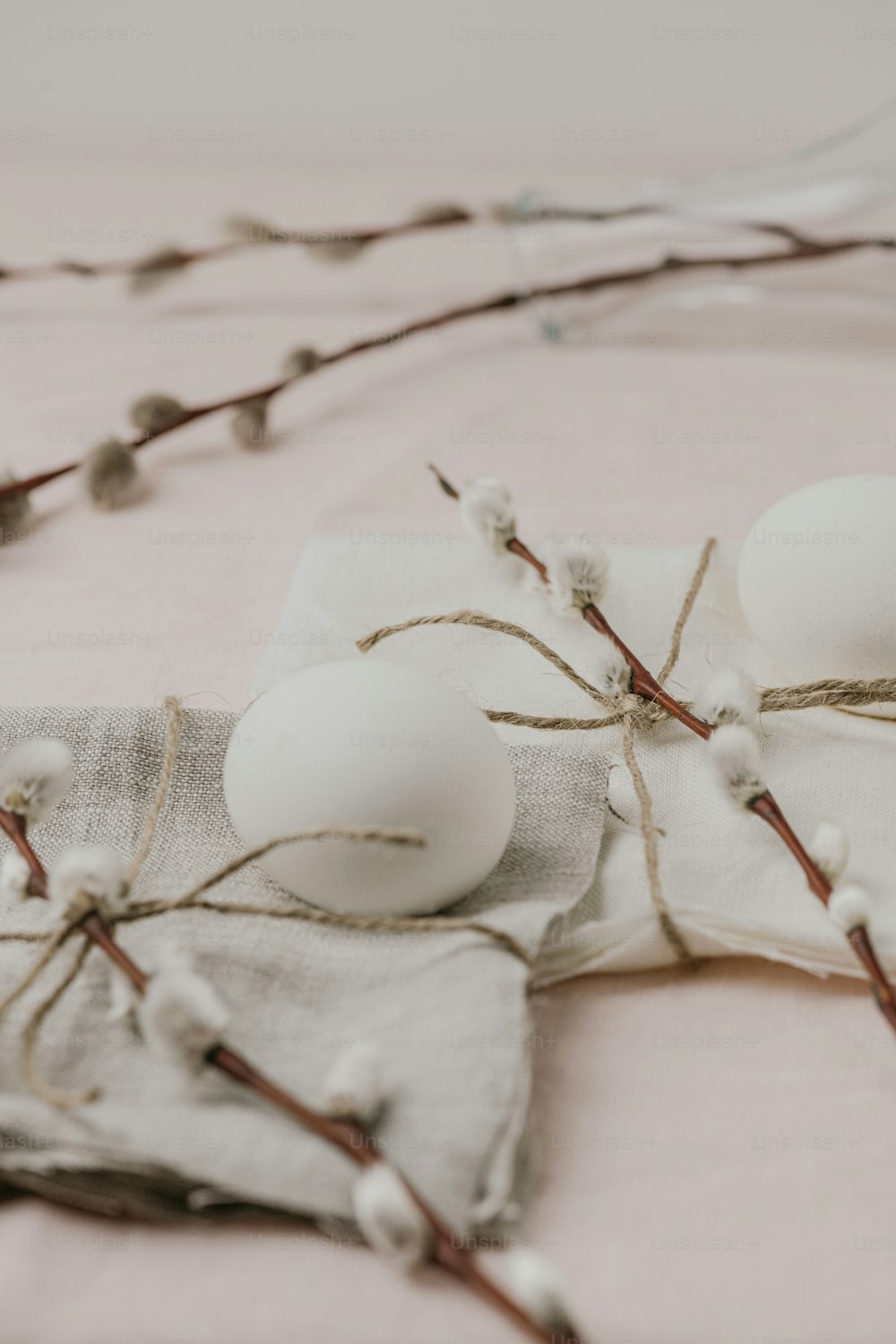 three eggs are sitting on a cloth on a bed