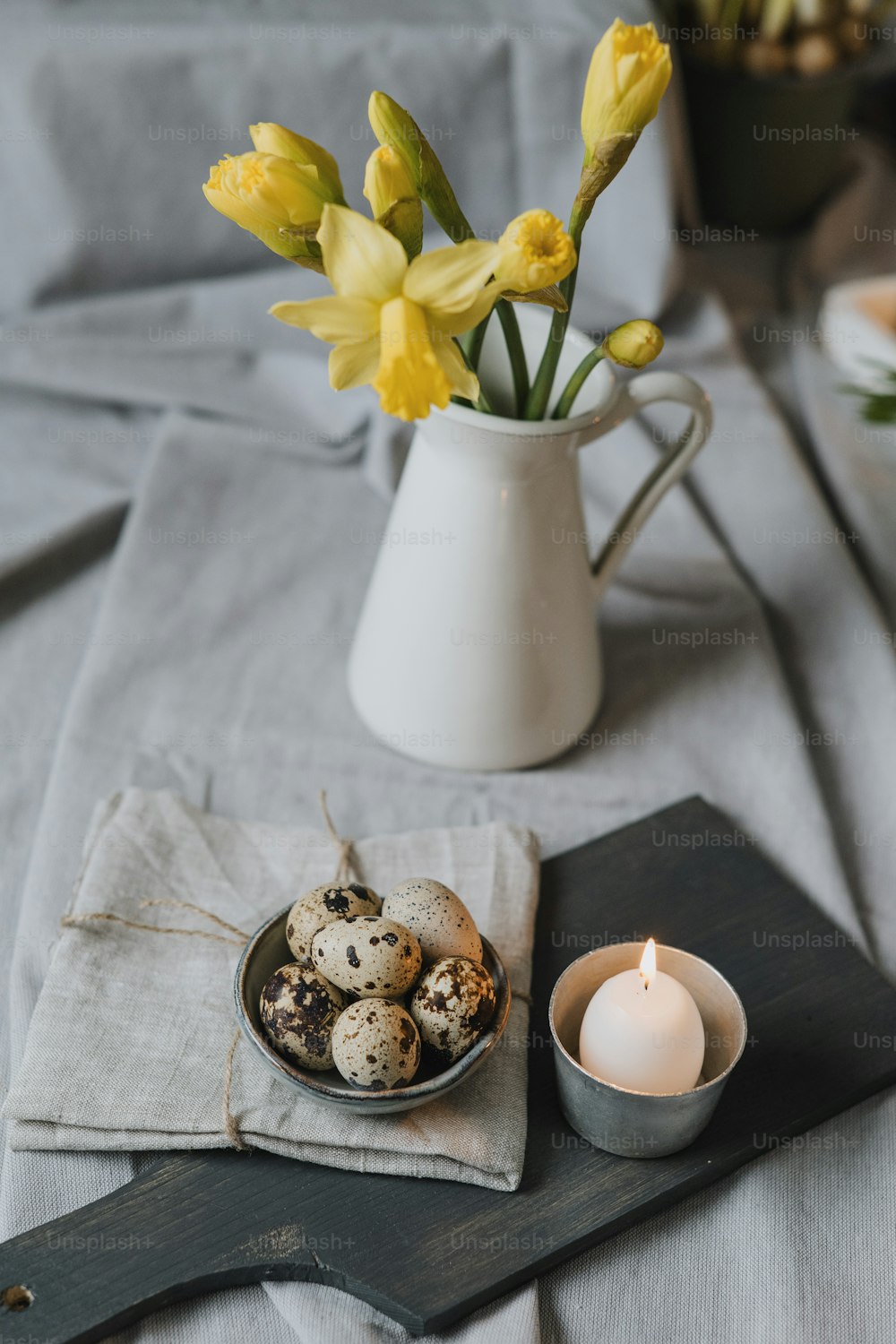 a plate of quails and a cup of flowers on a table