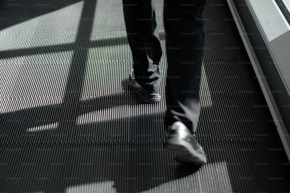 a person walking down an escalator in a building