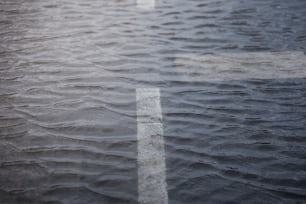 a cross is reflected in a puddle of water