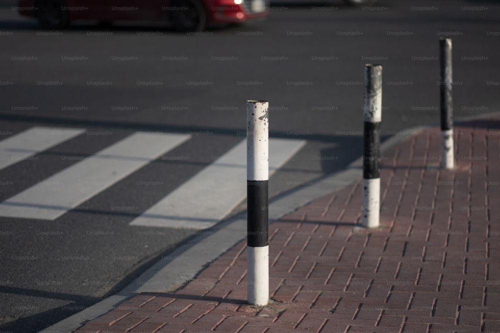 a couple of poles sitting on the side of a road