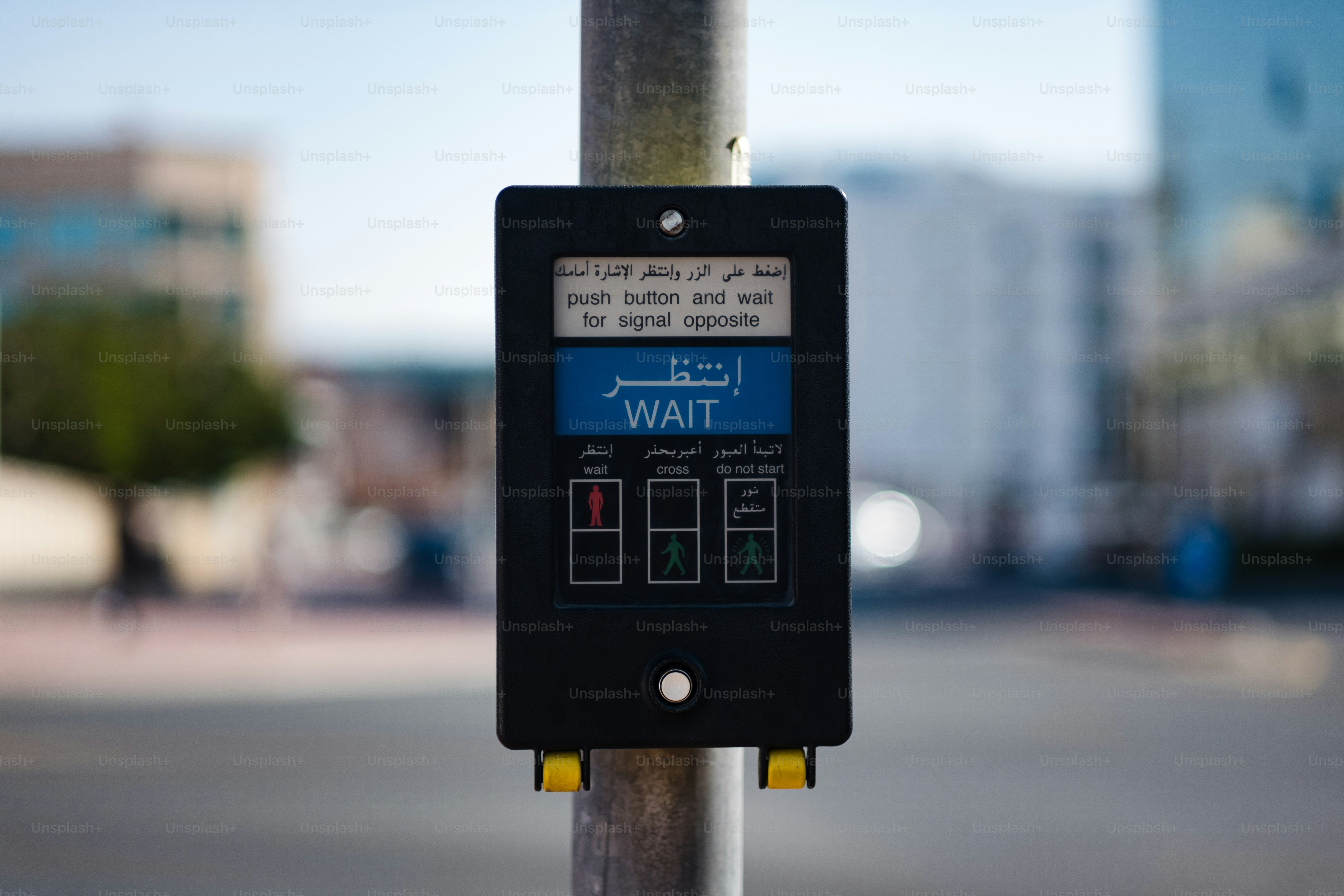 a street sign on a pole with buildings in the background