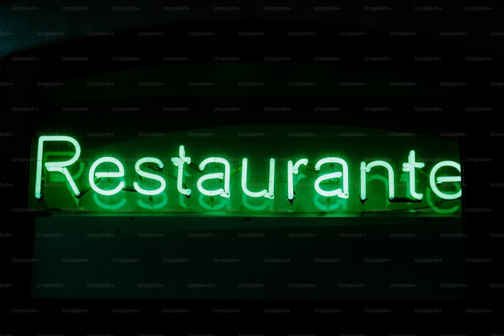 a restaurant sign lit up in the dark
