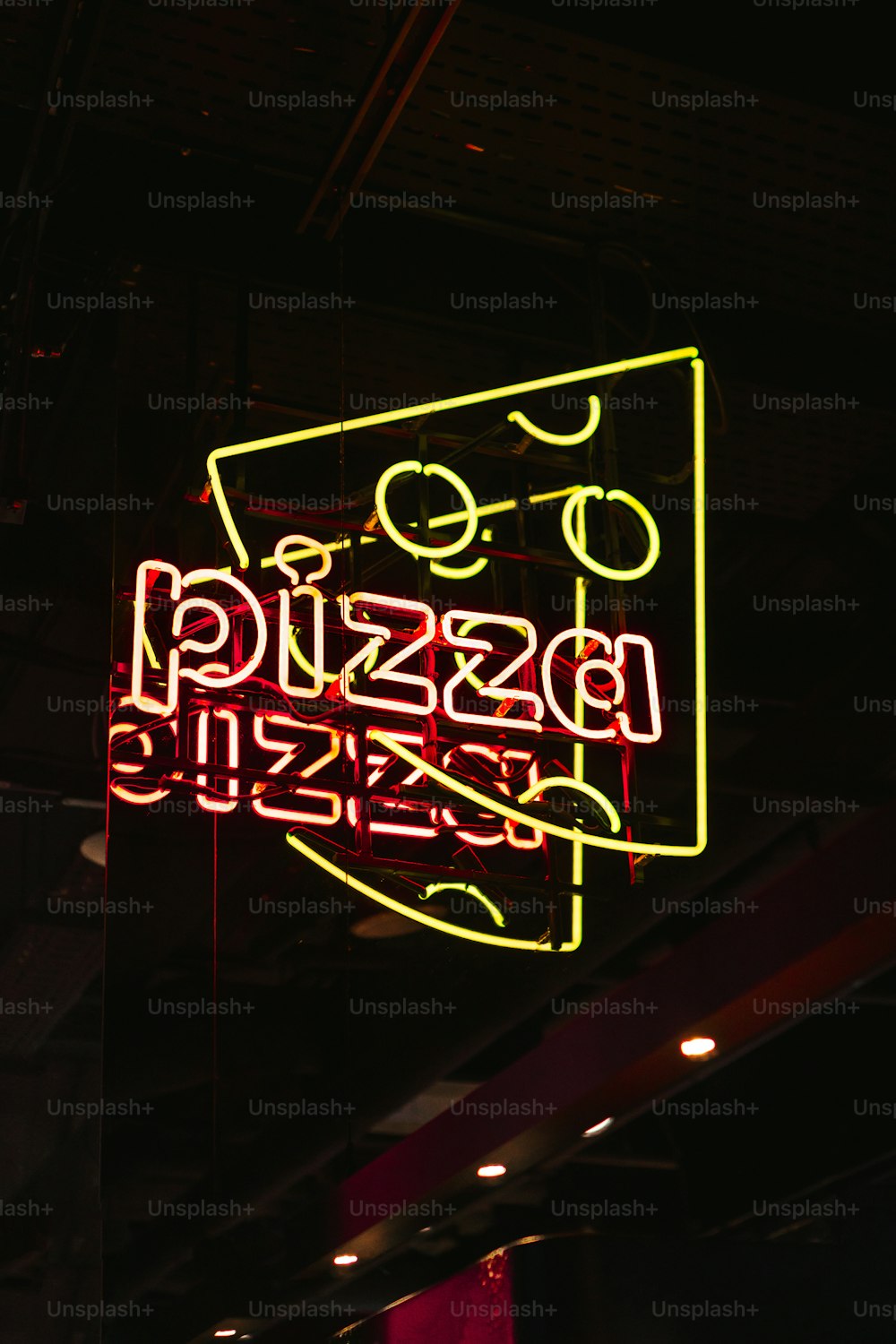 a neon sign hanging from the ceiling of a building