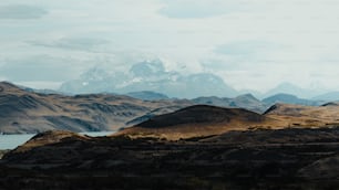 a view of a mountain range with a lake in the foreground