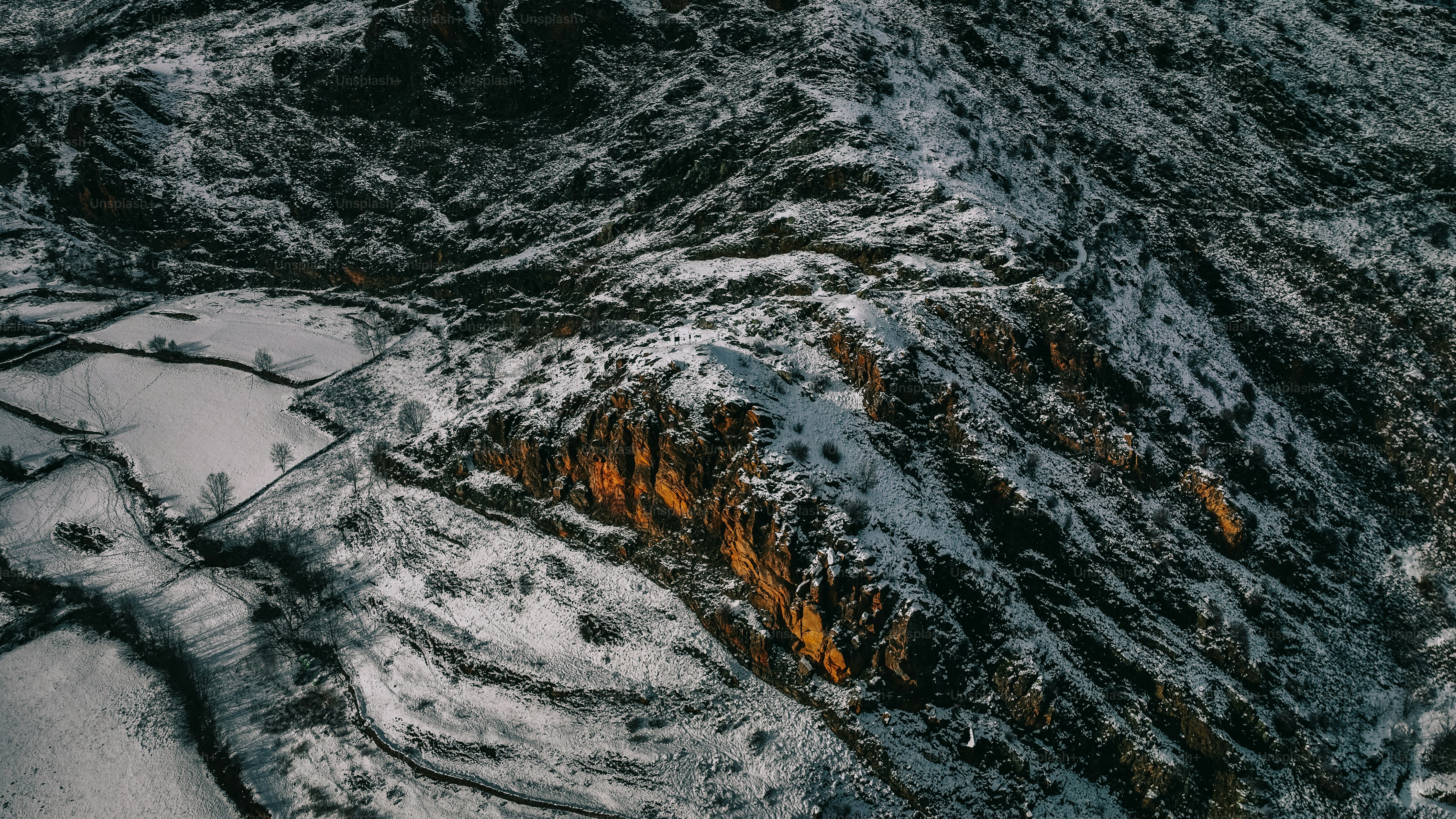 an aerial view of a snow covered mountain