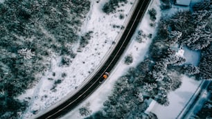 an aerial view of a road in the snow