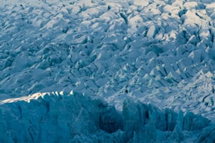 얼음으로 덮인 큰 산 위를 날아가는 비행기