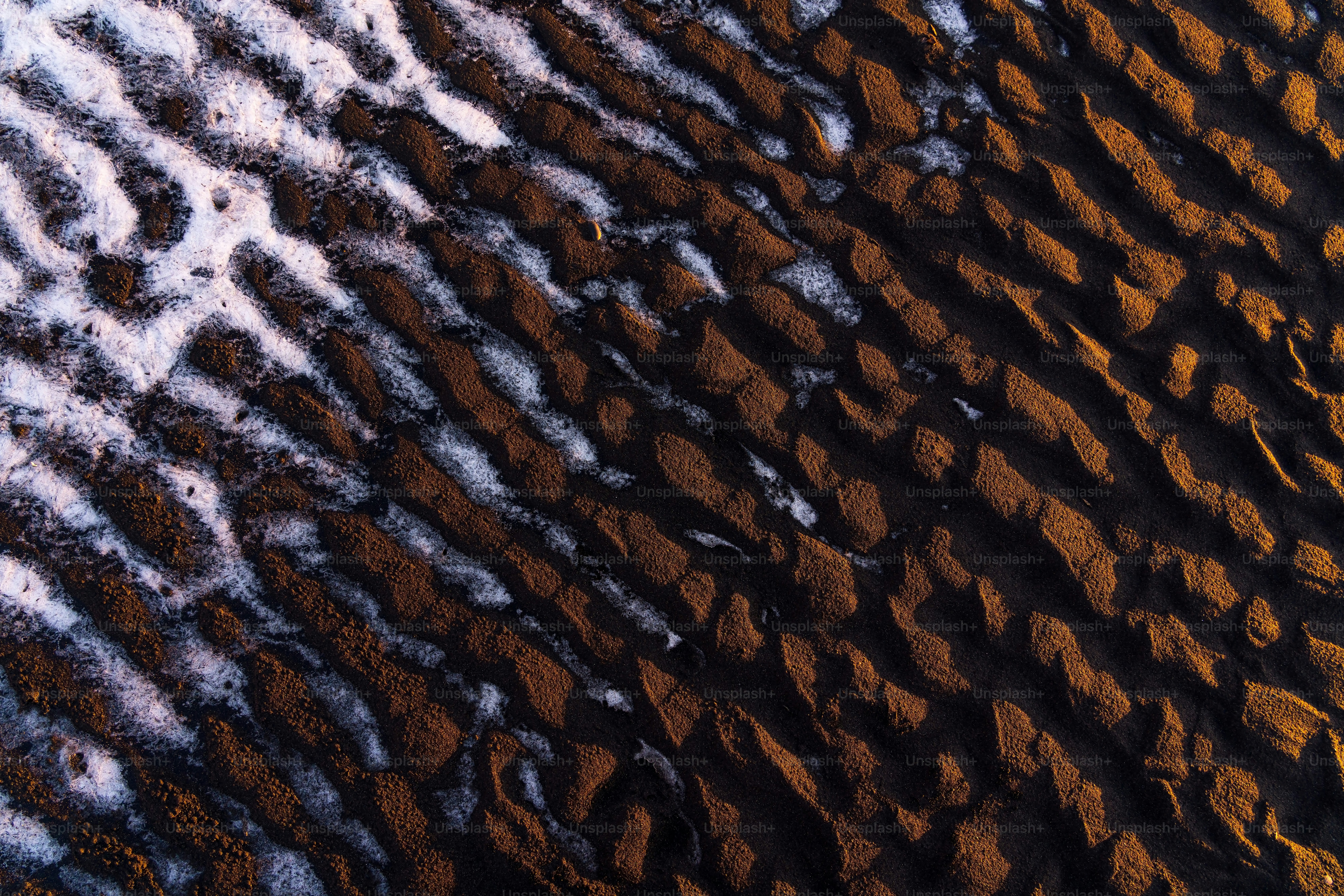 a close up of the sand and water on a beach