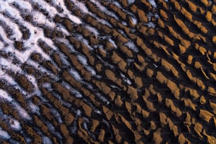 a close up of the sand and water on a beach