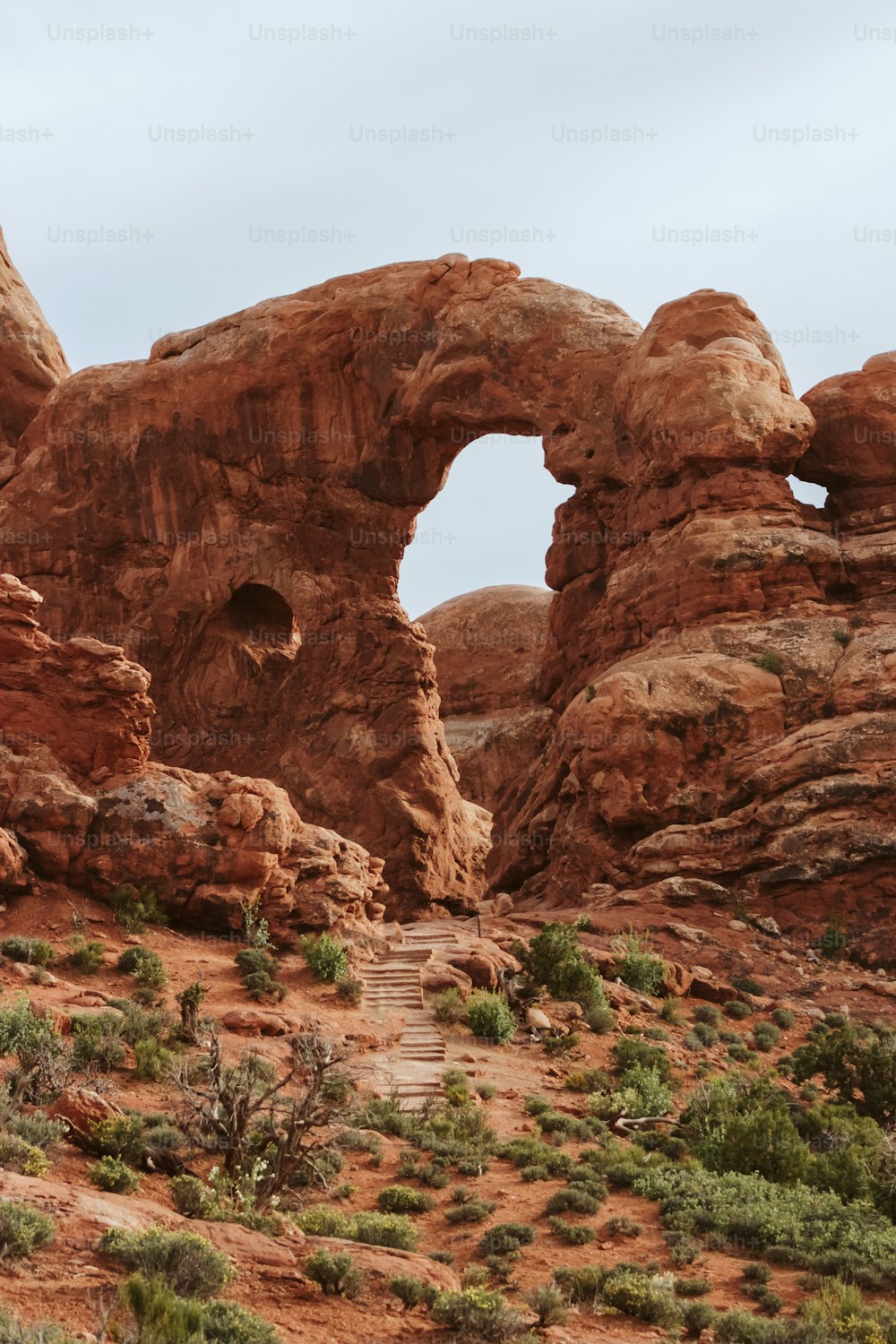 a large rock formation with a bridge in the middle of it