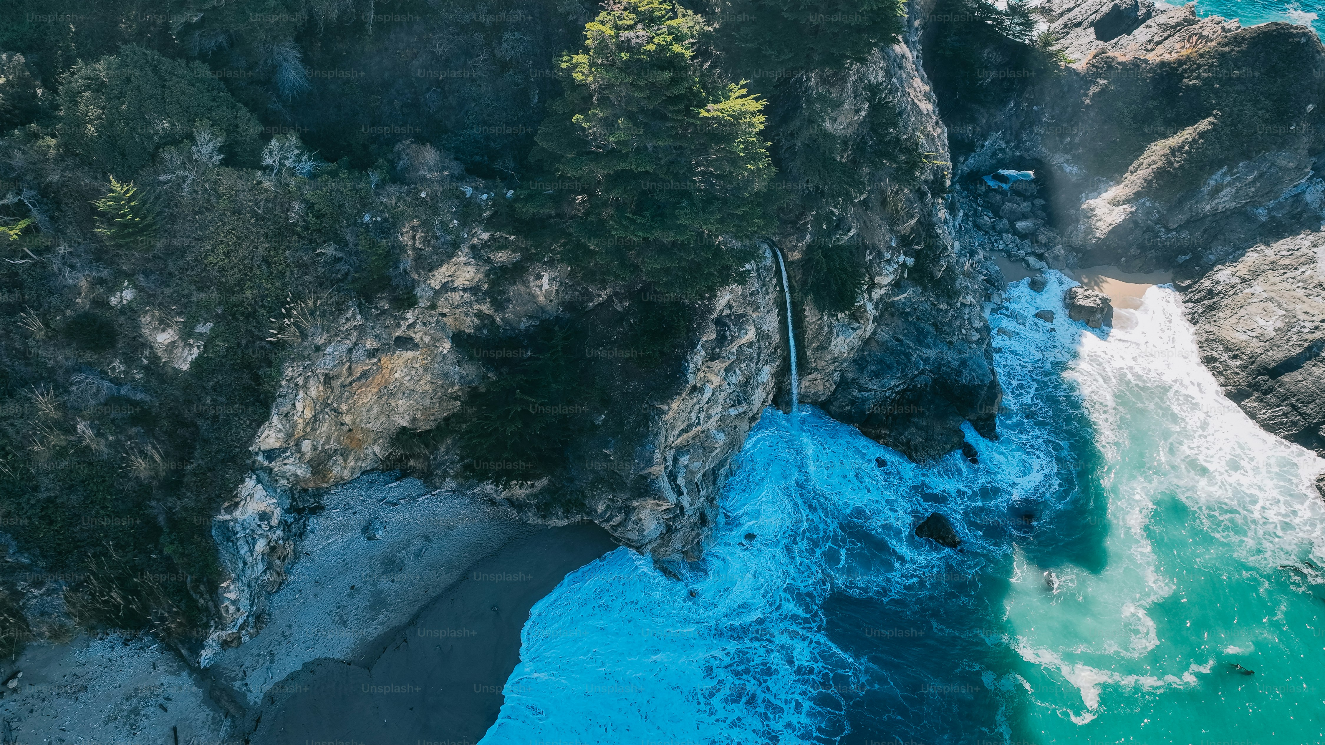 an aerial view of the ocean and cliffs