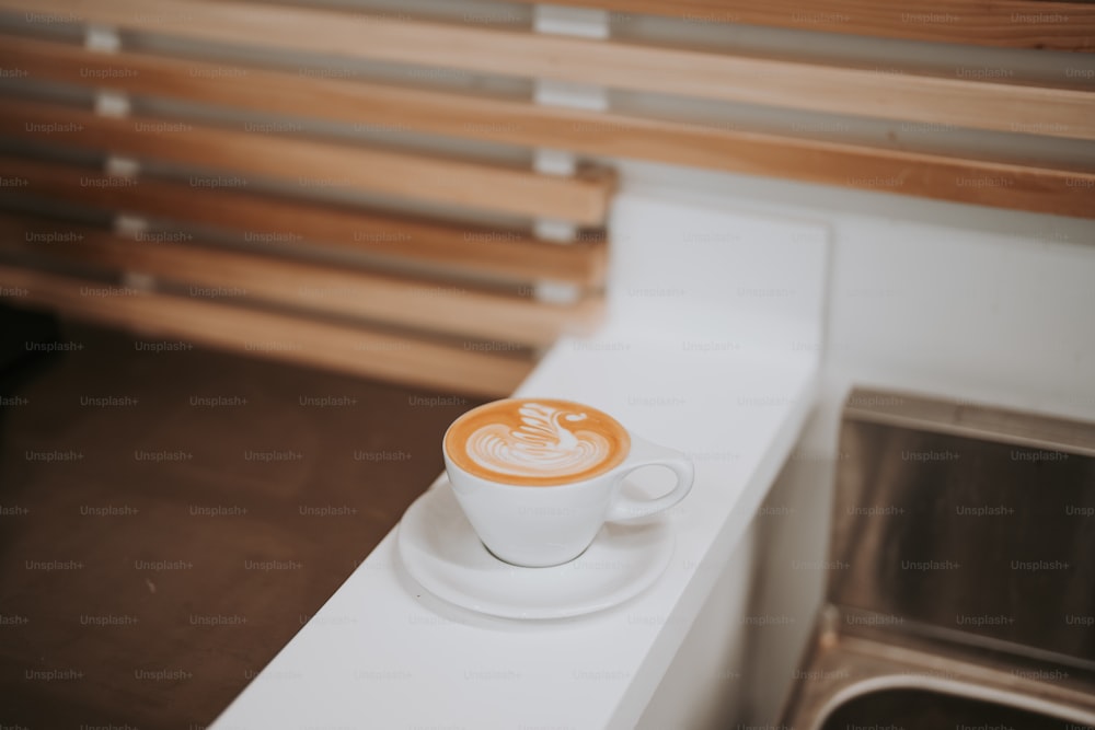 a cup of coffee sitting on top of a white counter