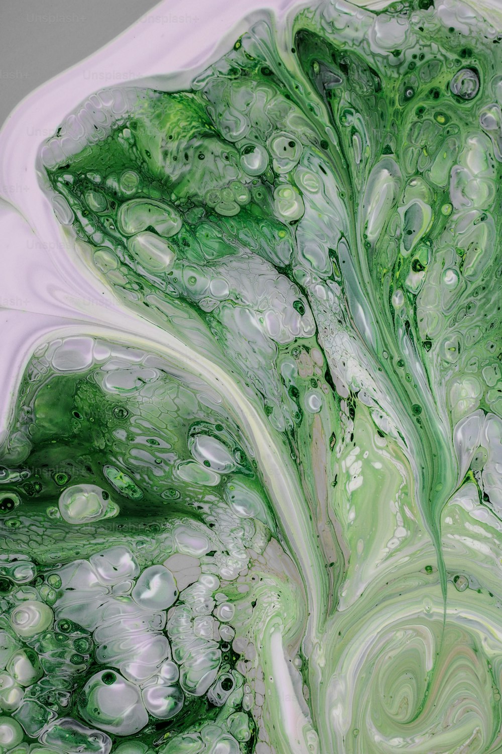 a close up of a green and white liquid