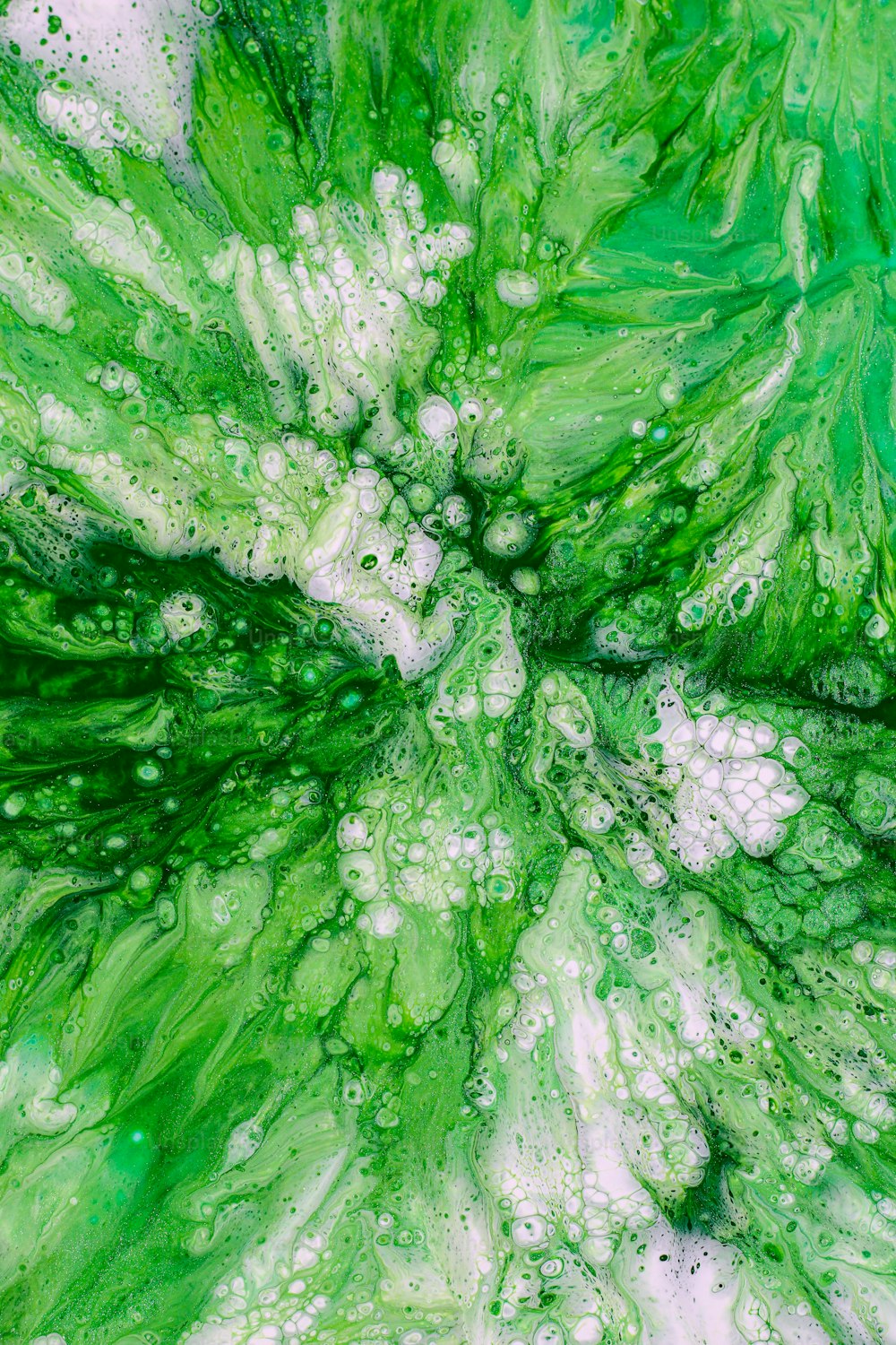 a close up of a green and white painting