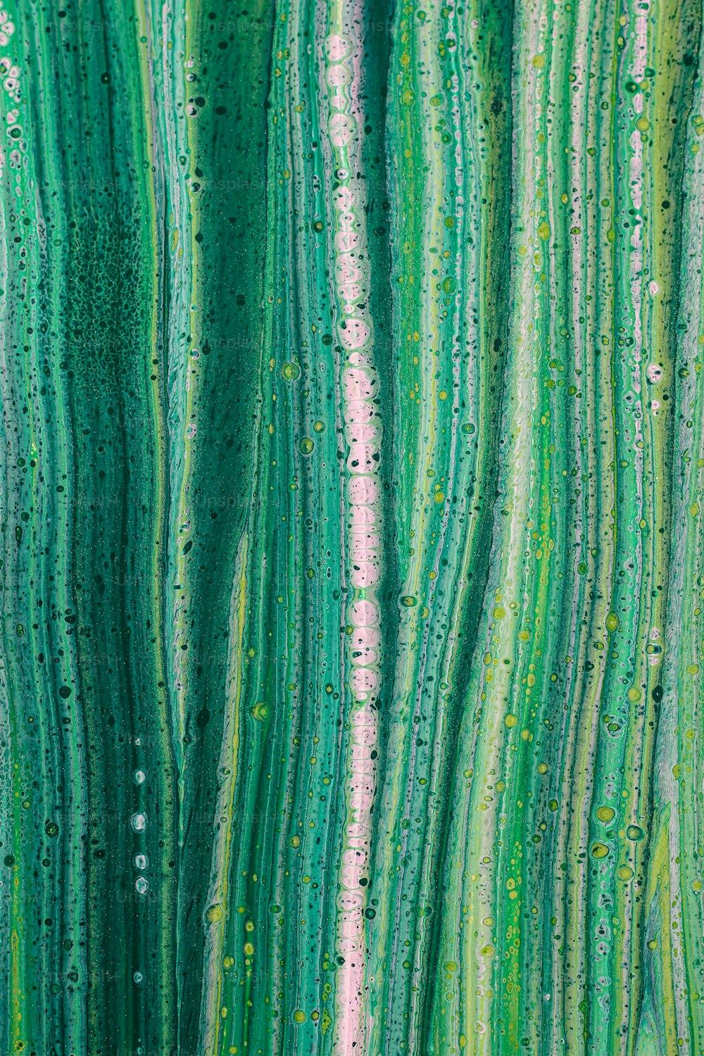a painting of green and pink lines with drops of water on them