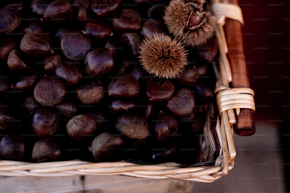 a basket filled with lots of chestnuts sitting on top of a table