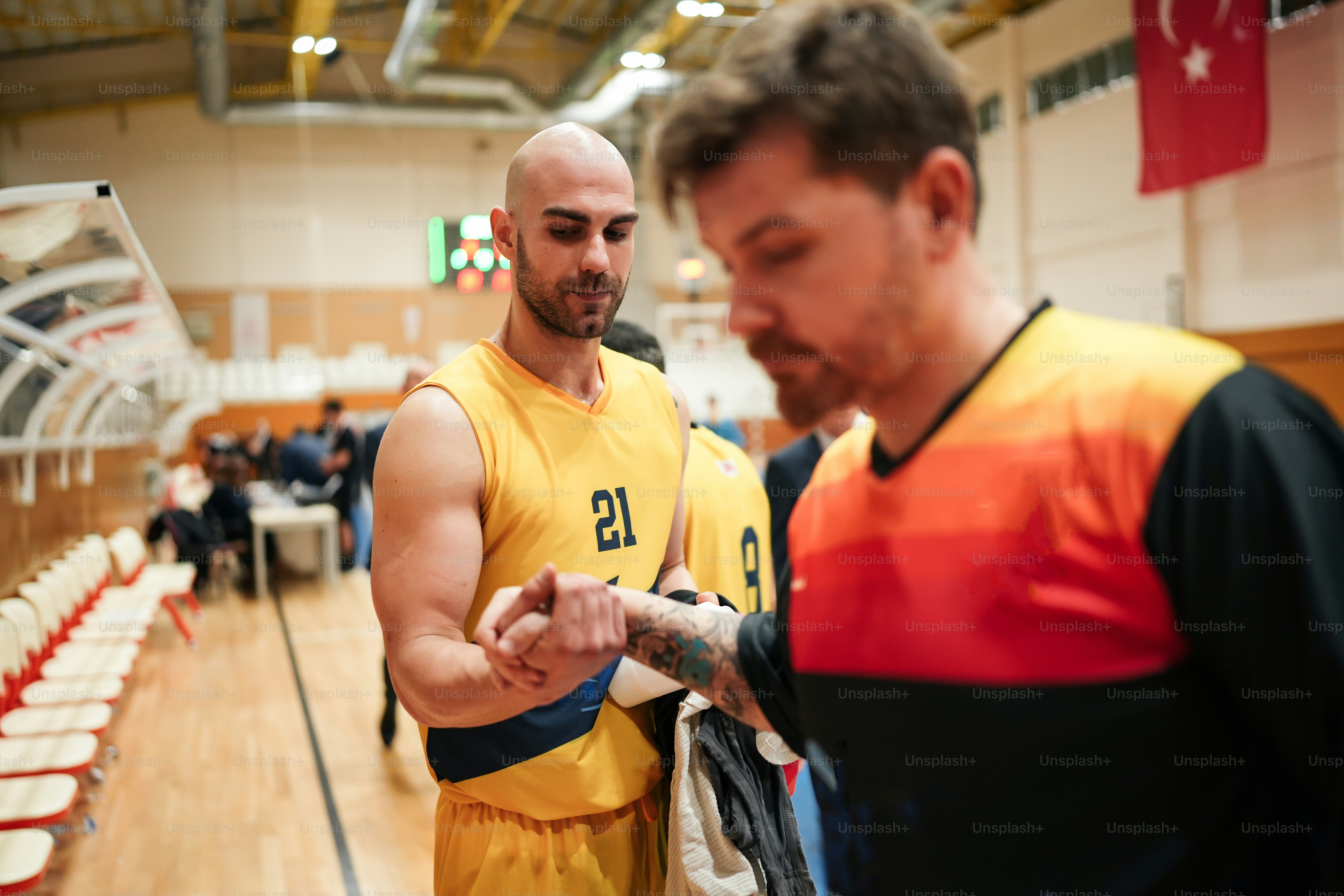 a man in a yellow and black uniform looking at his cell phone