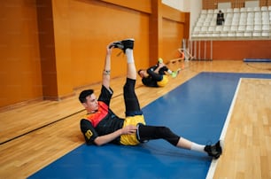 a man laying on the floor in a gym