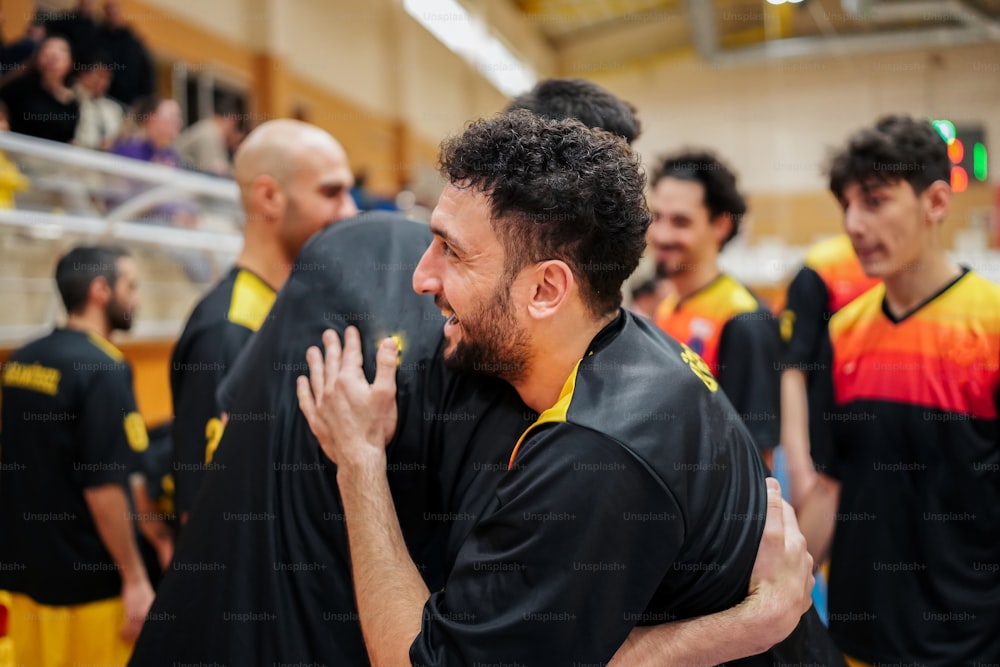 a group of men standing next to each other in a gym