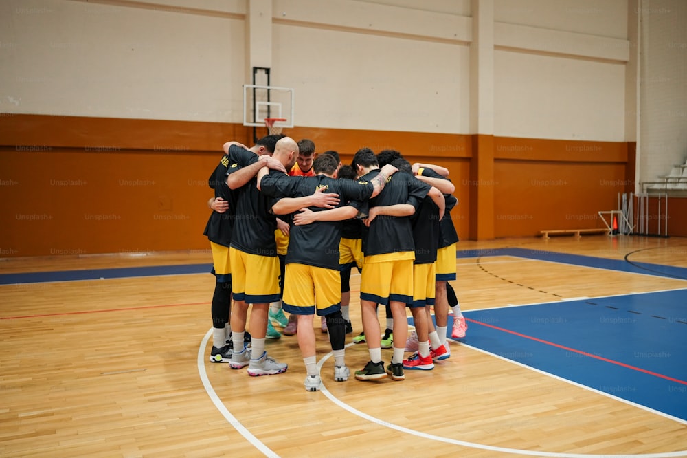 a group of young men standing on top of a basketball court