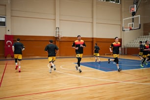 a group of young men playing a game of basketball