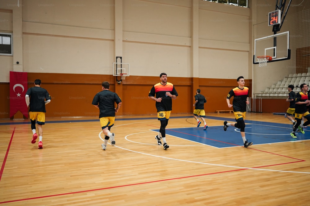 a group of young men playing a game of basketball