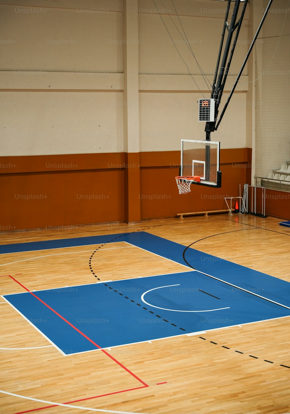 an indoor basketball court with a basketball hoop