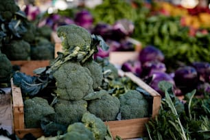 a pile of broccoli sitting on top of a wooden box