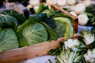 a wooden box filled with lots of green vegetables