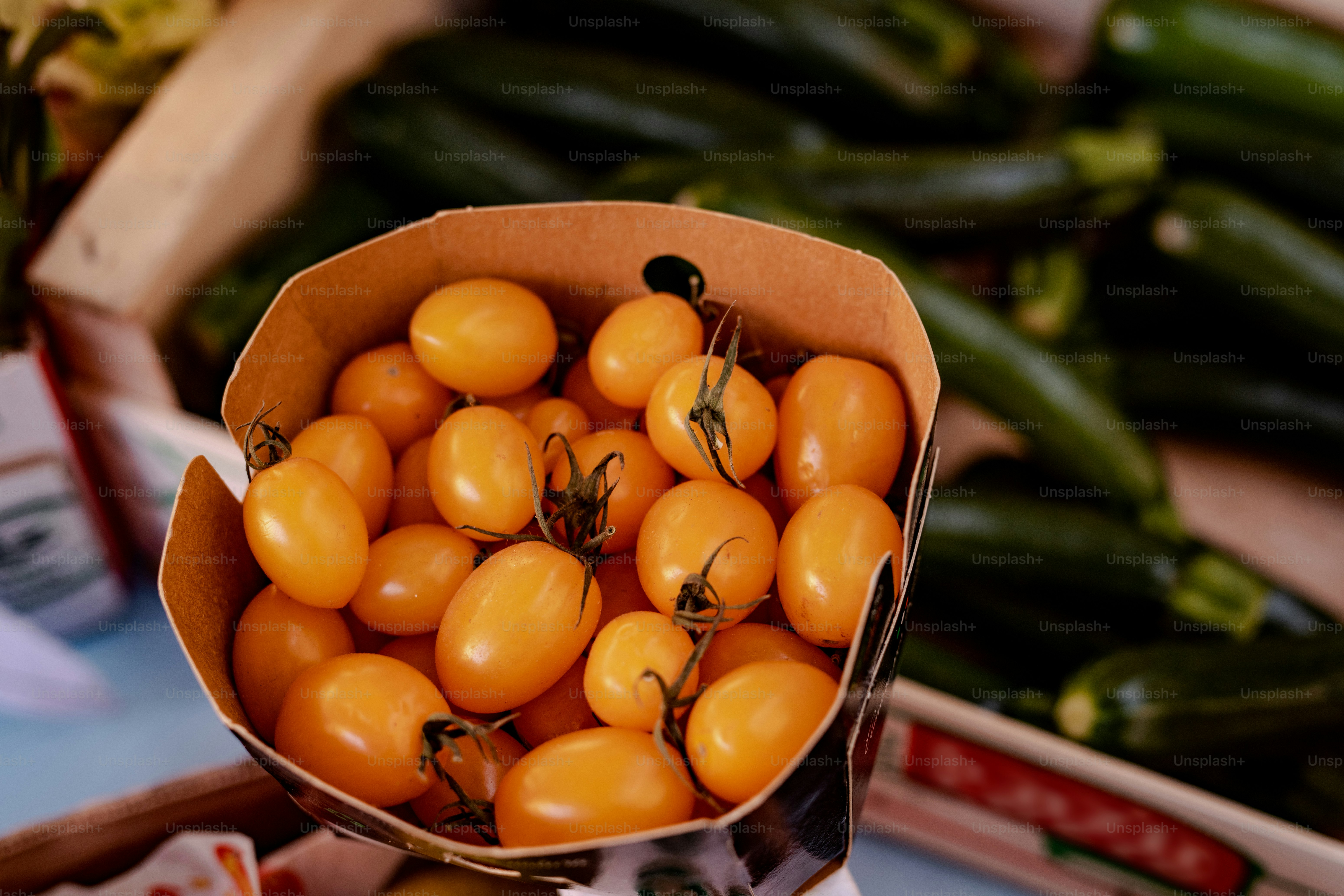 a cardboard box filled with lots of tomatoes