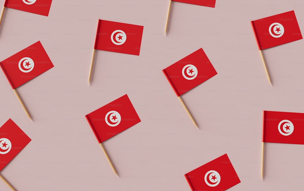 a group of red flags on a pink background