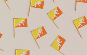 a group of orange and yellow flags on sticks