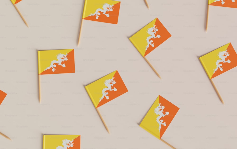 a group of orange and yellow flags on sticks
