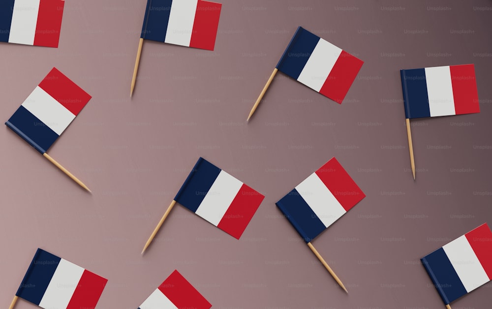 a group of small flags on toothpicks on a pink background