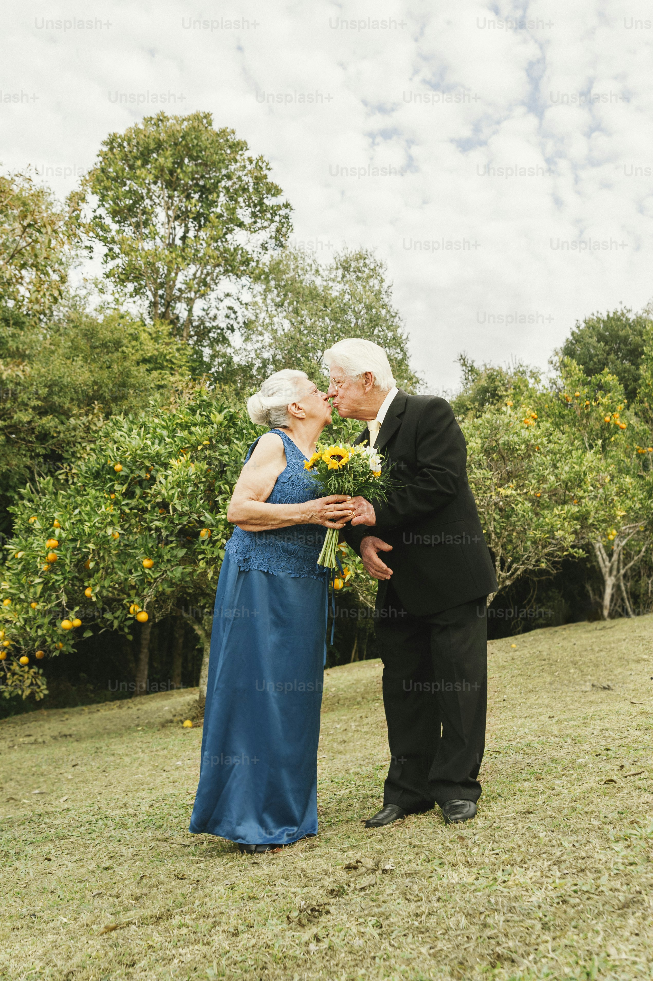 a man and a woman kissing in a field