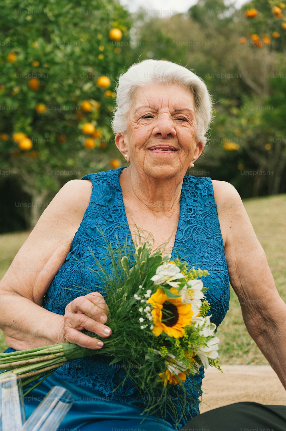 an older woman holding a bouquet of flowers