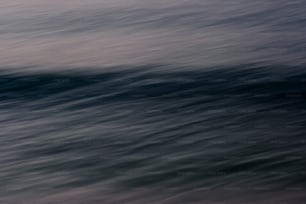 a person riding a surfboard on a wave in the ocean