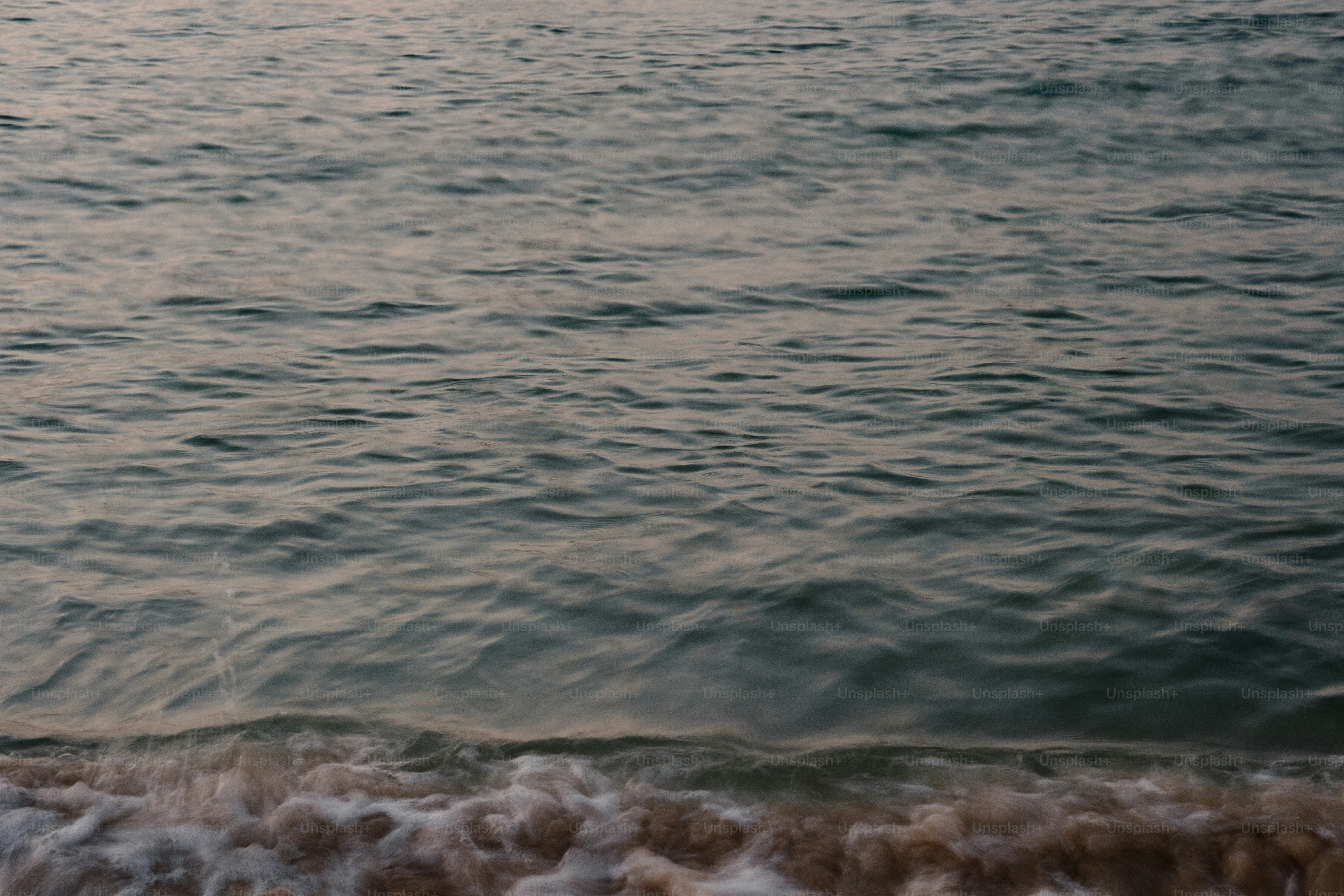a person standing on a surfboard in the water