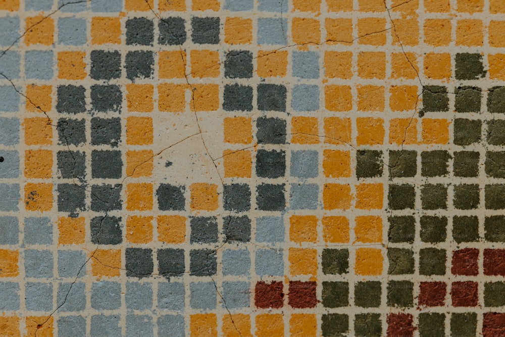 a close up of a tiled wall with different colors