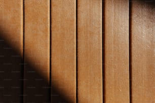 a shadow of a clock on a wooden wall