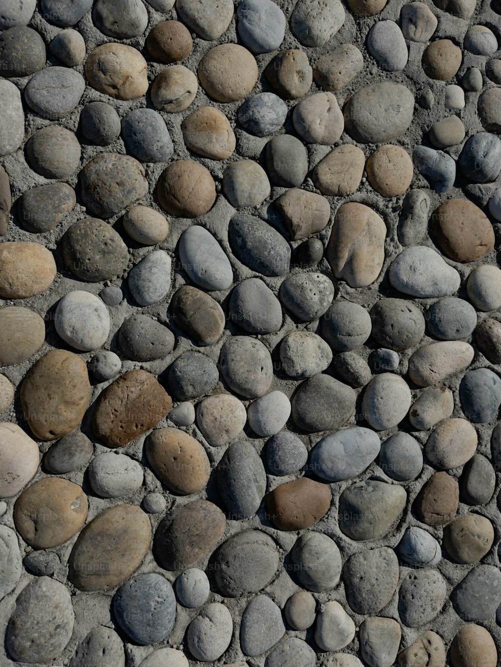 a close up of a stone wall with rocks on it