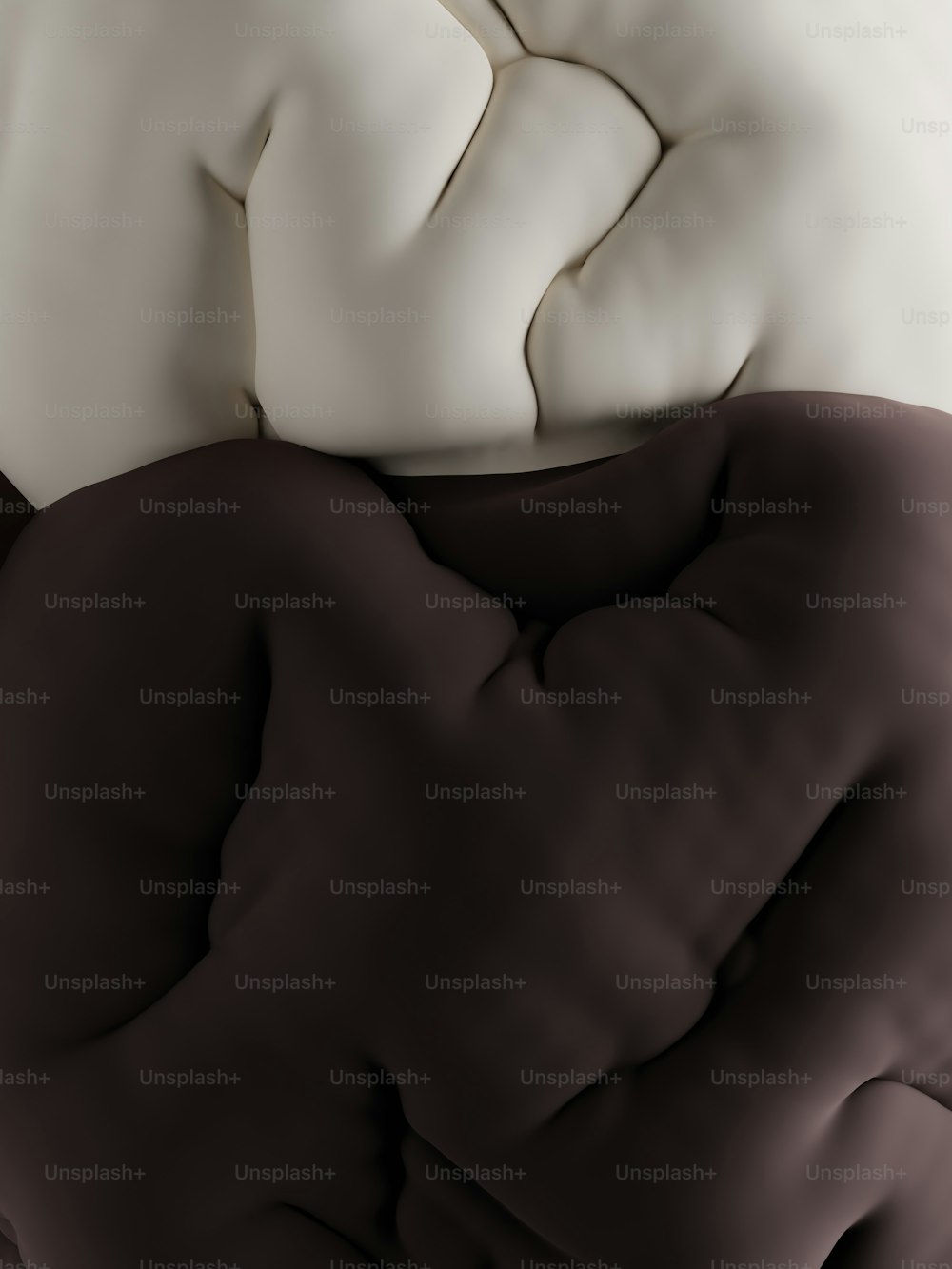 a close up of a bed with a white and brown comforter