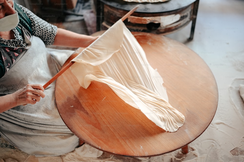 a woman in an apron working on a piece of art