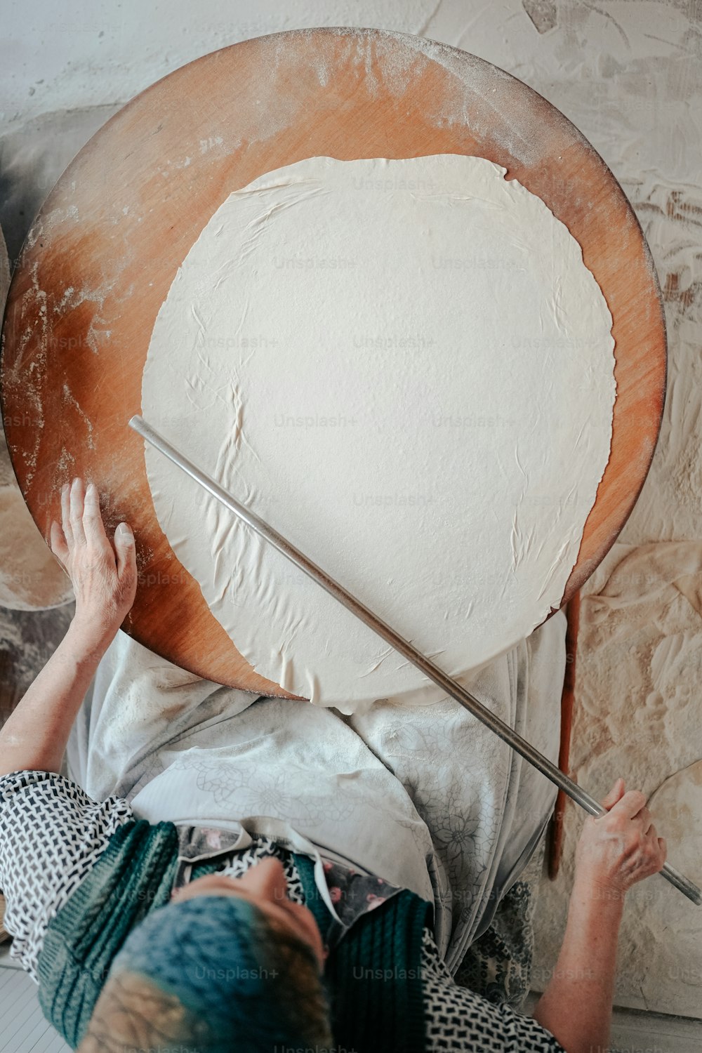 a woman is working on a large piece of art