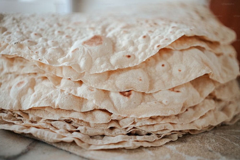 a stack of tortilla sitting on top of a table