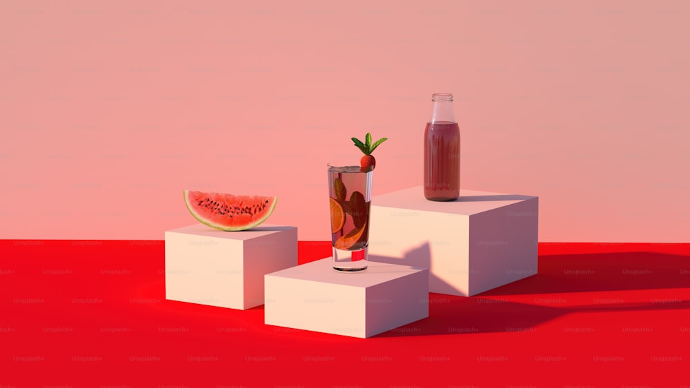 a watermelon and a drink on a pedestal
